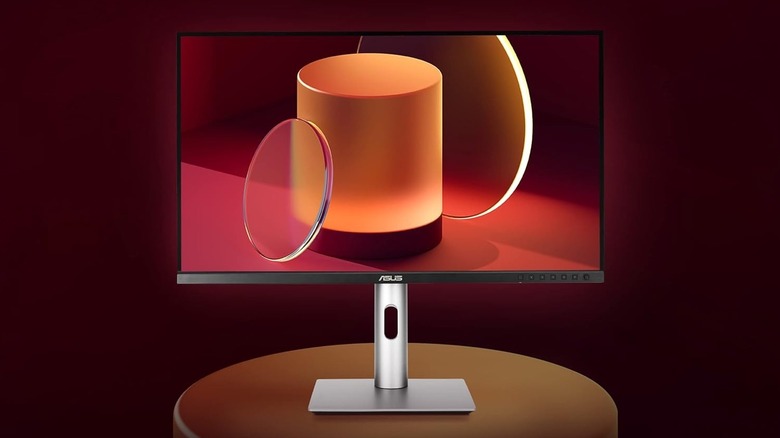 The Asus ProArt Display PA279CRV on circular table with red-tint background