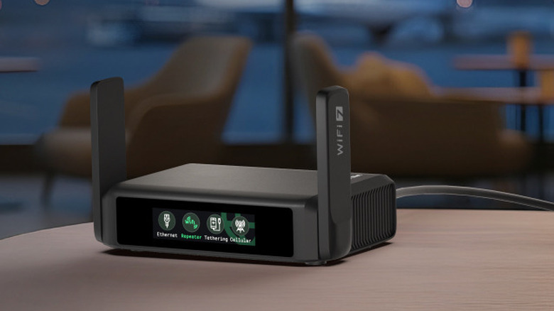 The GL.iNet Slate 7 Portable Travel Router on a flat surface with blurred furniture in the background.