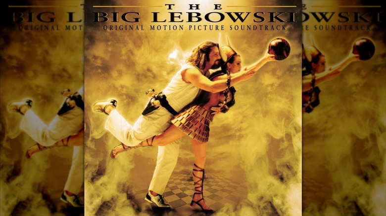 The front cover for "The Big Lebowski" original motion picture soundtrack, Jeff Bridges is embracing Julianne Moore from behind as she is holding a bowling ball in her right hand