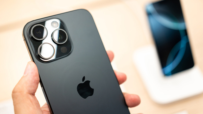 Person holding a black iPhone 16 Pro Max