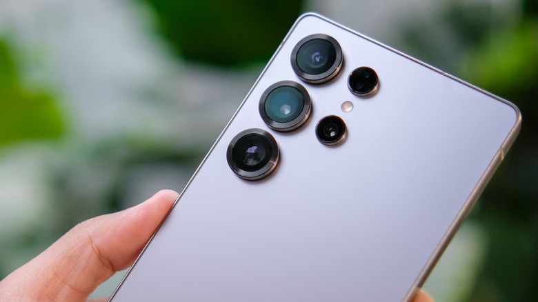 Person holding Samsung S25 ultra smartphone in gray color