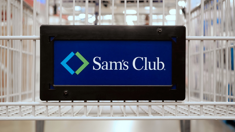 A closeup of a Sam's Club sign attached to a shopping cart