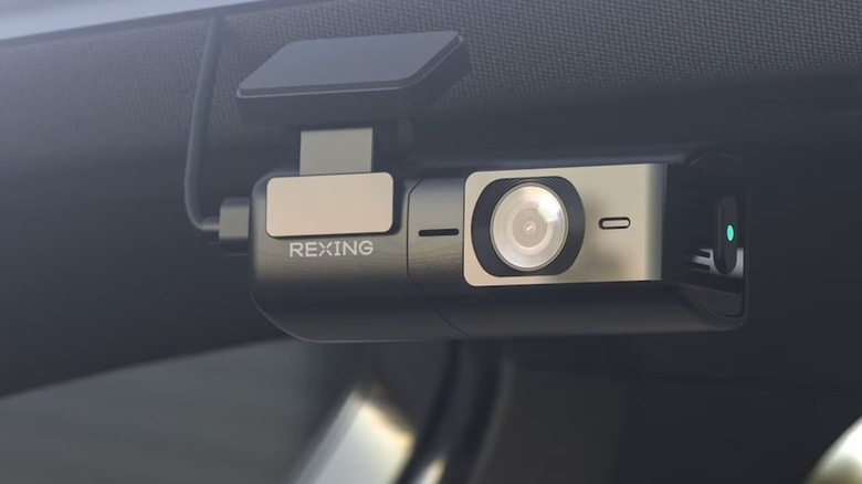A closeup of the Rexing Ultra HD Car Dash Cam attached to a the front window of a vehicle