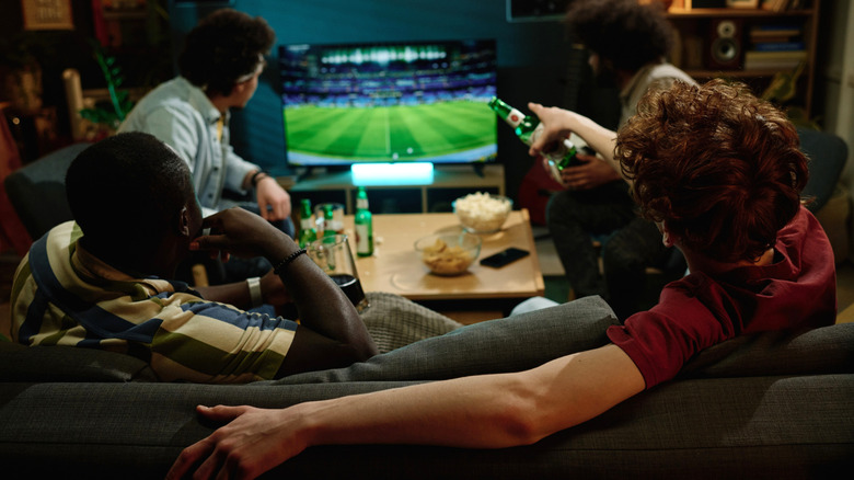 Several people watching sports on TV