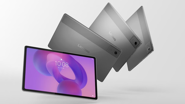 Four Leno Idea Tab Plus tablets are against a grey backdrop, three of the tablets have their screens facing away from the camera, while one is facing the camera to display its lock screen