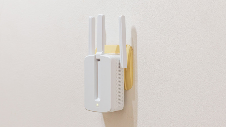 A Wi-Fi extender plugged into a wall socket