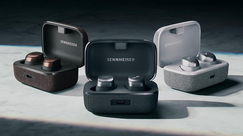 The Sennheiser Momentum True Wireless 4 earbuds and charging cases in three colors.