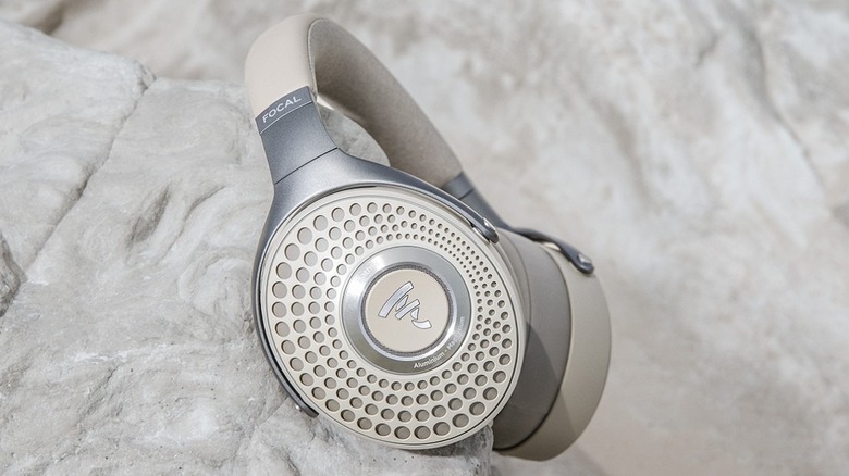 Focal Bathys wireless headphones shown resting on a stone surface.