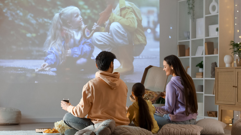 A family watching a movie in their living room.