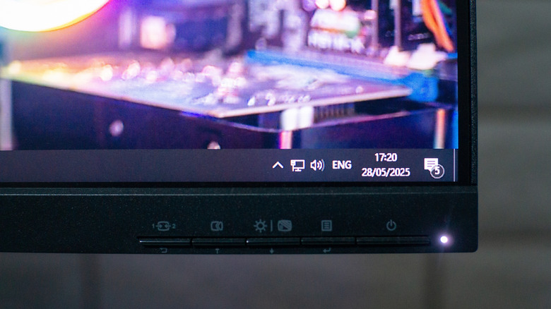 A computer monitor turned on, showing Quick Settings in the Windows 11 taskbar