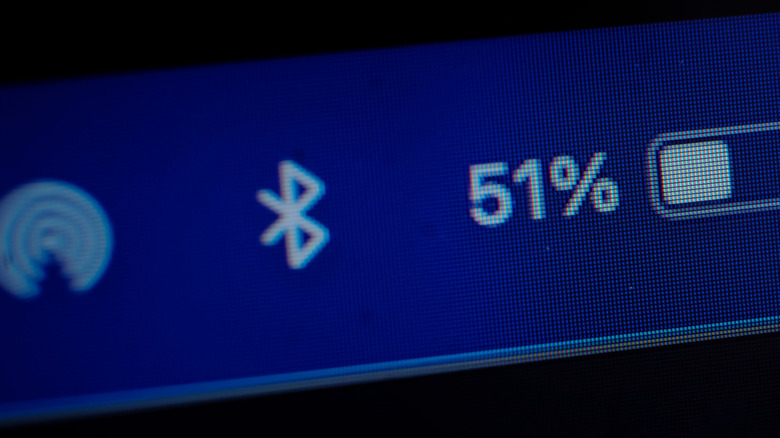 A zoomed-in view showing certain icon in a taskbar, including Bluetooth and battery percentage