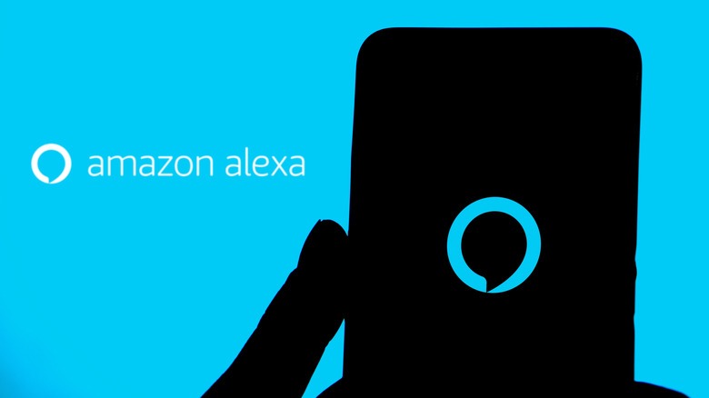 The Amazon Alexa logo on a smartphone in front of a screen displaying the name.