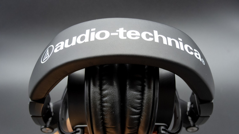 Hand holding Audio-Technica ATH-M50x headphones