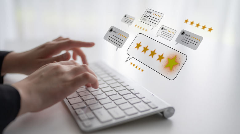 Concept of a person typing with icons of product reviews displayed