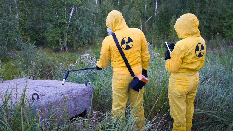 Two people measuring radiation levels