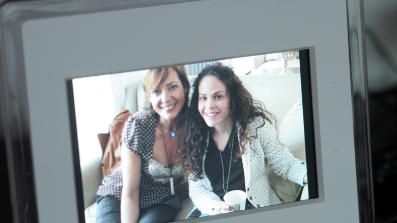 A picture of two women smiling showcased in a digital photo frame