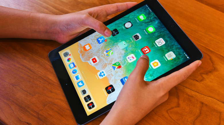 person holding ipad