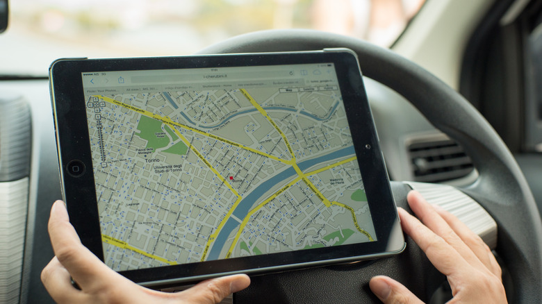 An iPad being used to navigate via Apple maps while driving