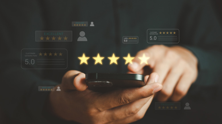 Holographic image of five stars above a smartphone