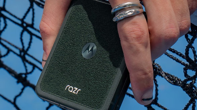 A person holding the green alcantara version of the Razr 60 Ultra