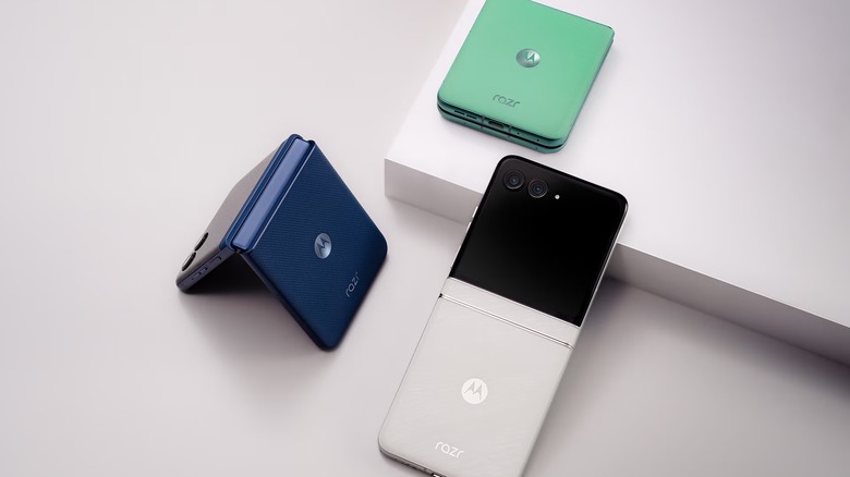 Different colors of the Motorola Razr 2025 lying against a off white background