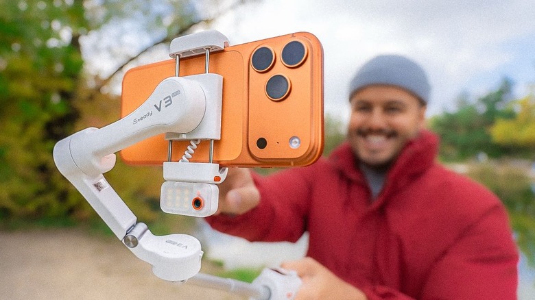 A person recording using their phone that's attached to the Hohem iSteady V3 Ultra gimbal