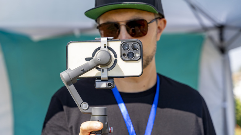 A person using a gimbal that's attached to their phone