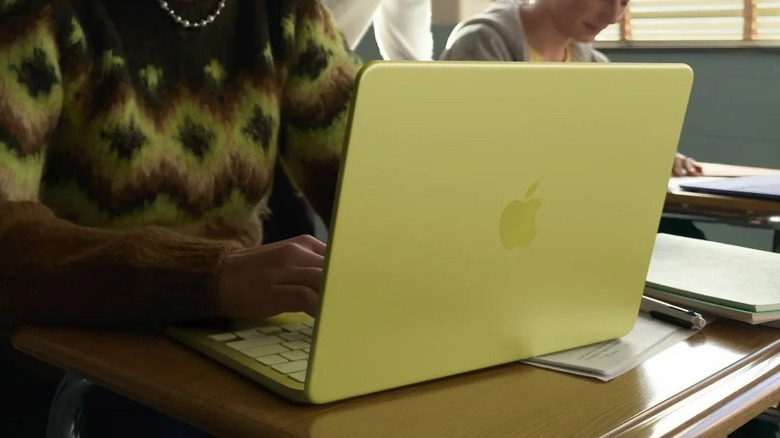 A person using the Apple MacBook Neo in a classroom.