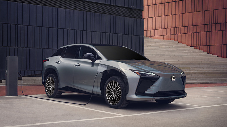 The 2026 Lexus RZ parked and plugged in for charging.