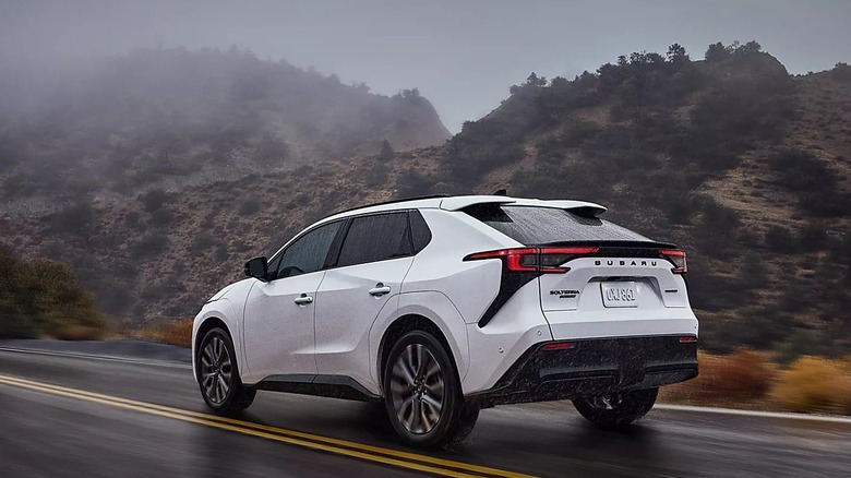 The 2026 Subaru Solterra, driving down a wet road.