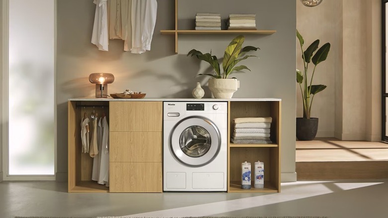 The Miele WXF660WCS washing machine in a laundry room.