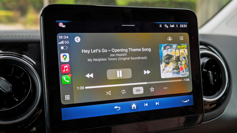Apple CarPlay dashboard in an electric Mercedes-Benz displaying music playback on screen