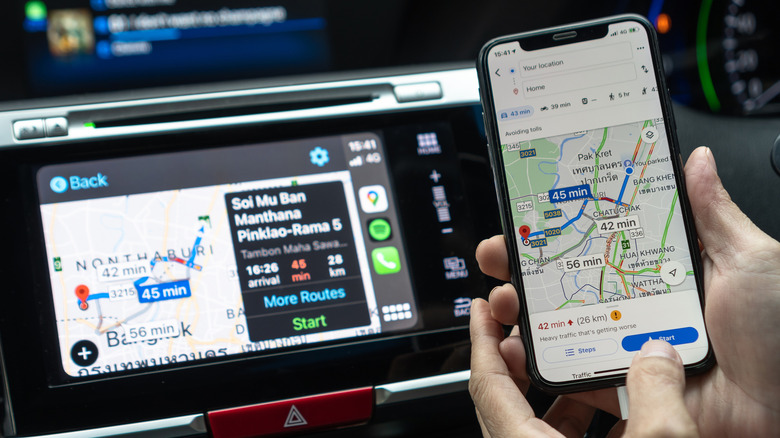 Google Maps app with Apple CarPlay on car screen dashboard and iPhone