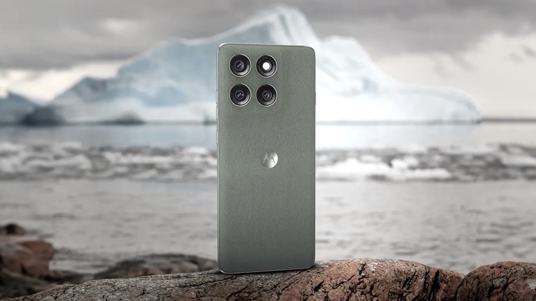 Motorola Edge 60 Pro in Pantone Shadow color standing on a rock