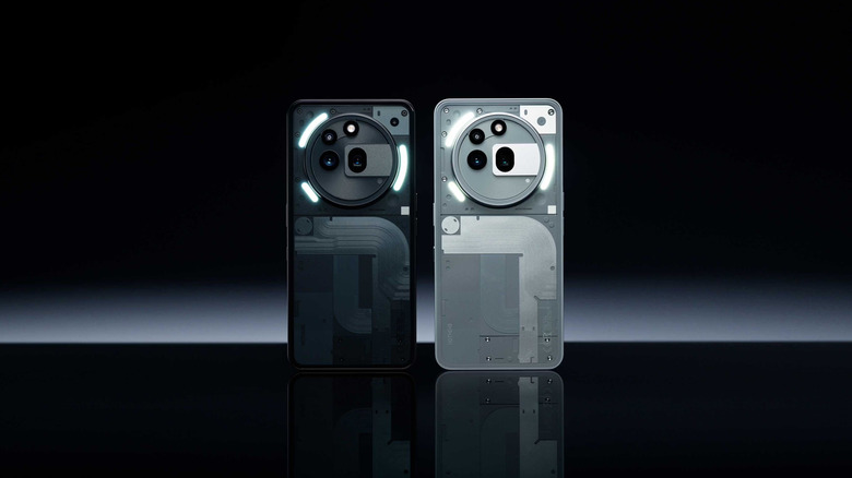 Both white and black variants of the Nothing Phone (3a) Pro against a black background