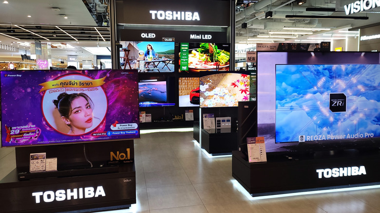 A range of Toshiba OLED TVs in a showroom.