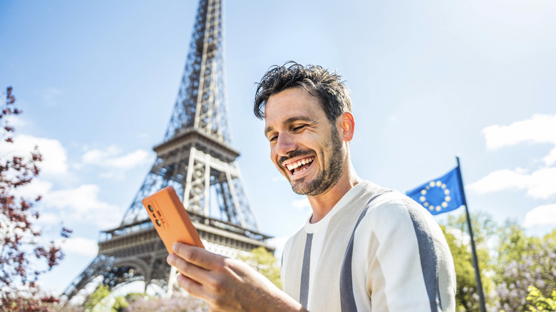 A tourist using a phone in Paris, France