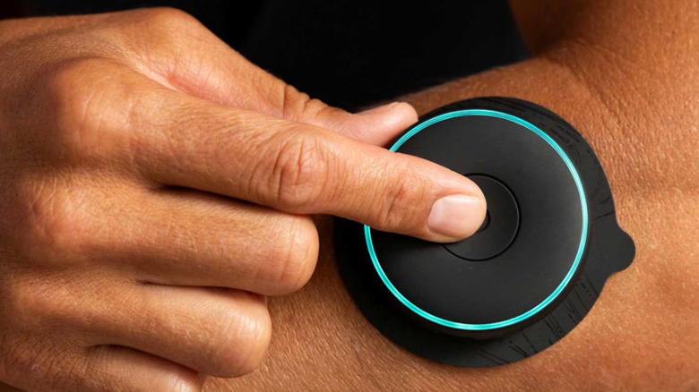 Person using Chirp Halo wireless muscle stimulator on their arm.