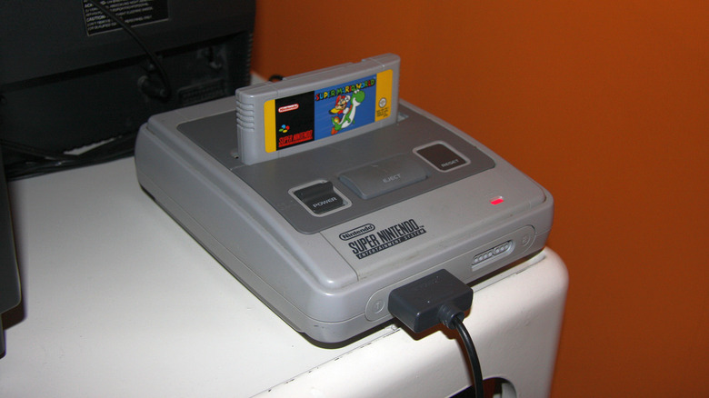 A Super Nintendo with a Super Mario World cartridge in it.
