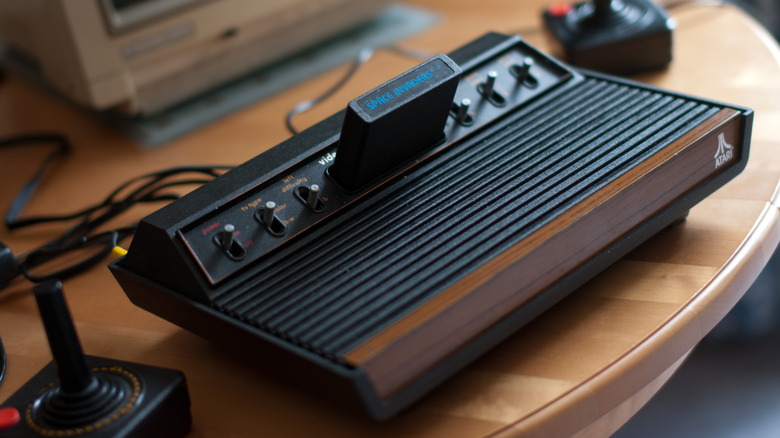 An Atari 2600 with joysticks and a Space Invaders cartridge