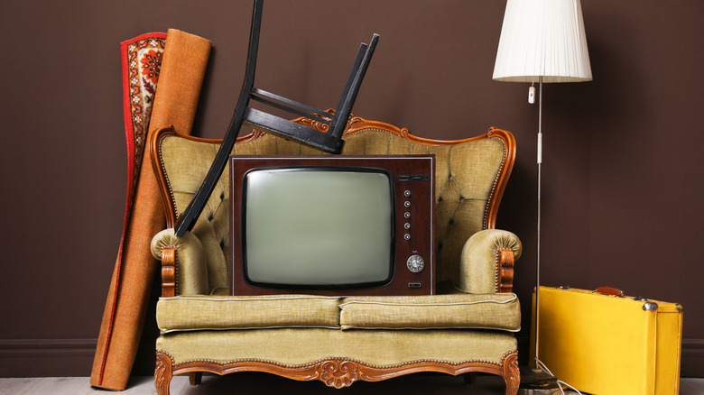 A retro TV left to sit with a chair stacked atop it