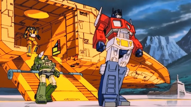 Optimus Prime, Hound, and Sunstreaker standing in The Transformers: The Movie