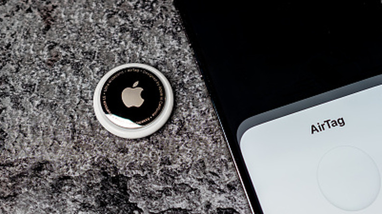 AirTag tracker with iPhone pairing screen.