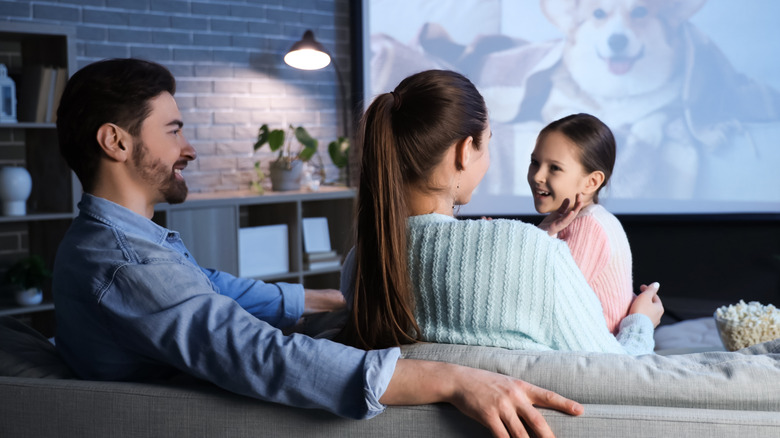 Family watching a movie together at home