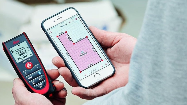 A person using the Leica DISTO D2 Laser Distance Measure alongside the Leica DISTO Plan app on an iPhone.