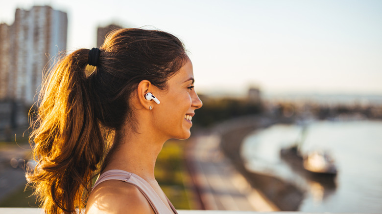 A woman outside wearing AirPods