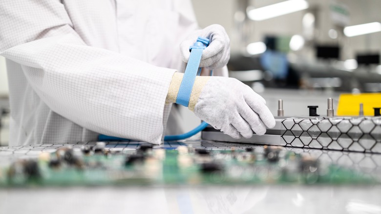 Worker in electronics factory wearing anti static bracelet.