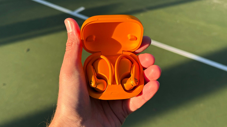 Powerbeats Pro 2 in orange in a basketball courtyard