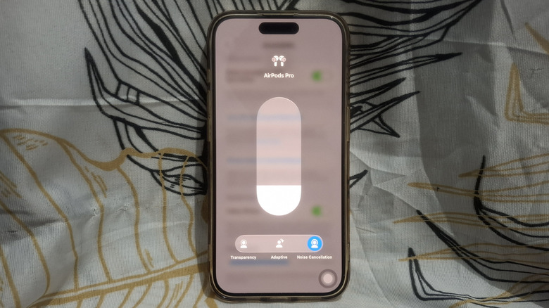 iPhone showing AirPods Noise Cancellation activation via Control Center