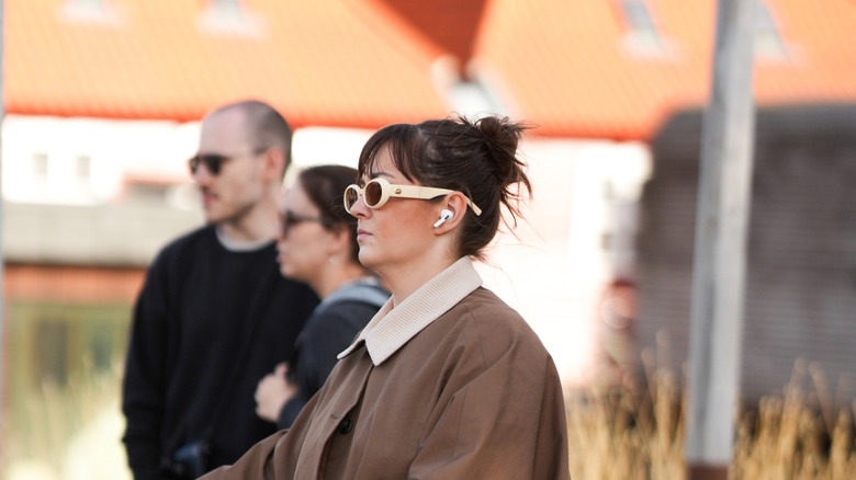 Woman wearing AirPods in a public space